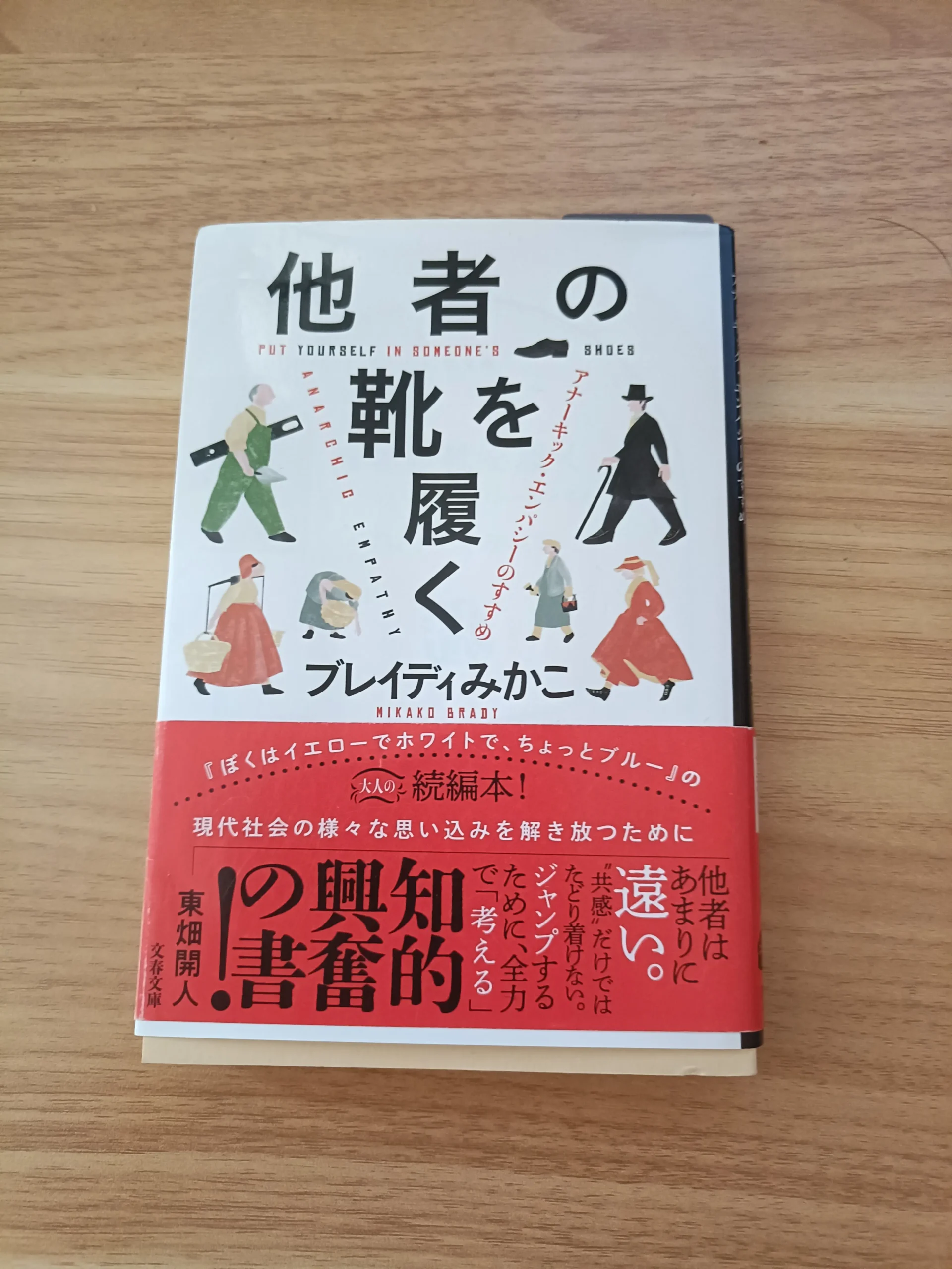 木の机に置いたブレイディみかこ著『他者の靴を履く』の表紙